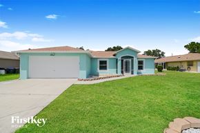 North Port house for rent - A blue house with a garage is for sale.