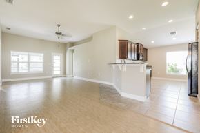 Punta Gorda house for rent - an empty kitchen and living room with a refrigerator and a counter