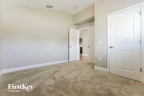 Punta Gorda house for rent - a bedroom with a carpeted floor and white doors
