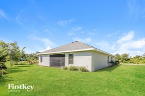 Punta Gorda house for rent - a small house with a grassy yard and a blue sky