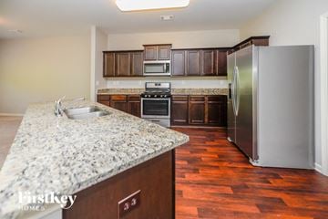 Pendergrass house for rent - A kitchen with a granite counter top and a refrigerator.