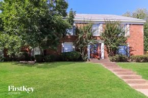 Memphis house for rent - A brick house with a green lawn in front.