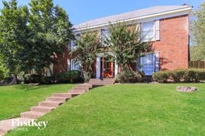 Memphis house for rent - A brick house with a green lawn in front.