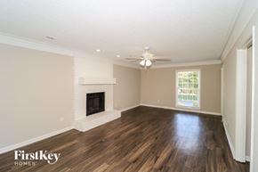Memphis house for rent - A spacious room with a fireplace and wooden floors.