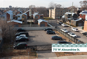 Detroit apartment for rent - A parking lot with cars and a sign that says 711 W Alexandrine St.
