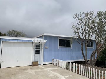 Summerland house for rent - a blue house with a white garage door and a tree