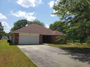 Deridder house for rent - A house with a garage and a driveway.