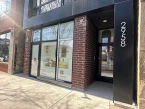 Chicago apartment for rent - the storefront of a store with glass windows and a black door