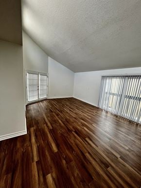 Seal Beach apartment for rent - A room with wooden flooring and a window with blinds.