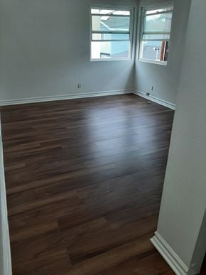 Seal Beach apartment for rent - A room with wooden flooring and a window.