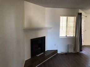 Long Beach apartment for rent - A living room with a fireplace and a television.