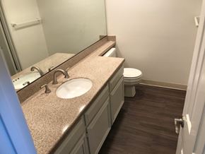 Long Beach apartment for rent - A bathroom with a sink, toilet, and mirror.