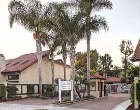 Long Beach apartment for rent - A sign that says "Village Grove" stands in front of a building.