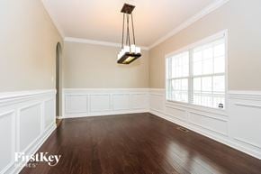 Clarksville house for rent - an empty dining room with wood flooring and a large window