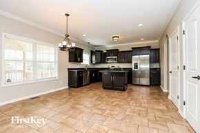 Clarksville house for rent - a kitchen with black cabinets and stainless steel appliances and a large window