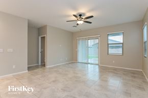 Tucson house for rent - a spacious living room with tile flooring and a ceiling fan
