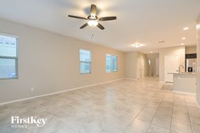 Tucson house for rent - a clean and empty living room with a ceiling fan