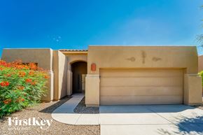 Tucson house for rent - A house with a garage door and a logo that says "Firstkey" on the bottom left.