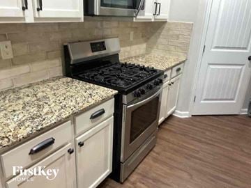 Dallas house for rent - an updated kitchen with granite counter tops and a stainless steel stove