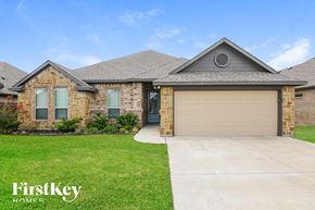 Weatherford house for rent - a home with a driveway and a garage door