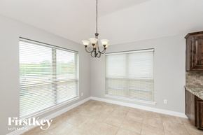 Weatherford house for rent - a dining room with two windows and a chandelier