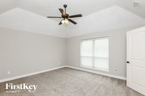 Weatherford house for rent - a bedroom with a ceiling fan and a window