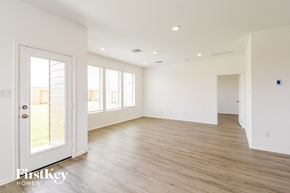 La Marque house for rent - the living room and dining room of a home with white walls and wood floors