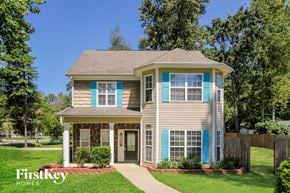 Huntersville house for rent - a beige house with blue shutters and a sidewalk