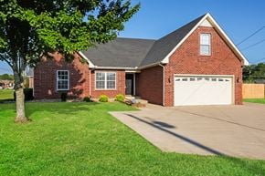 Smyrna house for rent - a red brick house with a white garage door