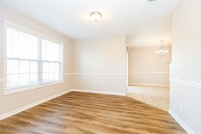 Smyrna house for rent - a living room with a large window and a wooden floor