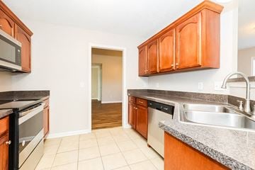 Smyrna house for rent - a large kitchen with wood cabinets and stainless steel appliances