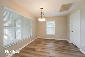 Cape Coral house for rent - an empty dining room with wood flooring and a large window