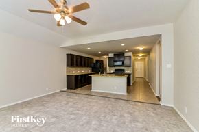 San Antonio house for rent - an open kitchen and living room with a ceiling fan