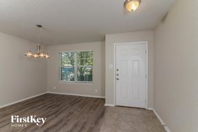 San Antonio house for rent - the spacious living room with a white door and a window