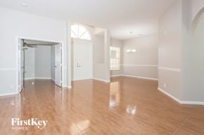 Port St. Lucie house for rent - A spacious room with wooden flooring and white walls.