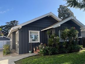 Long Beach apartment for rent - the exterior of a black house with a yard and plants