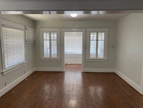 Long Beach apartment for rent - an empty living room with a hard wood floor and windows