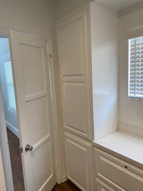 Long Beach apartment for rent - a closet with white cabinets and a window and a door