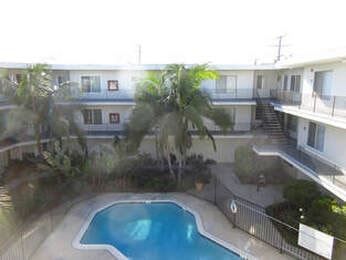 Long Beach apartment for rent - A pool in a backyard surrounded by a fence.