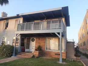 Long Beach apartment for rent - A house with a balcony and a door with a wreath on it.
