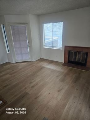 Long Beach apartment for rent - A room with a fireplace and wood flooring.
