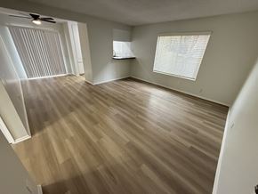 Long Beach apartment for rent - A room with wooden flooring and a ceiling fan.