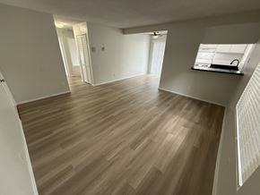 Long Beach apartment for rent - A room with wooden flooring and white walls.