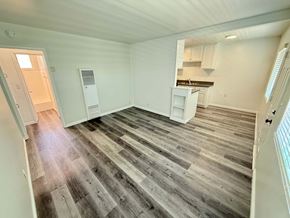 Long Beach apartment for rent - A room with wooden flooring and white walls.