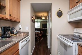 Union house for rent - A kitchen with a white stove top oven and a white microwave above it.