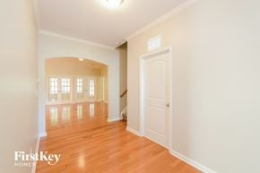 Winston Salem house for rent - A room with wooden floors and a white door.
