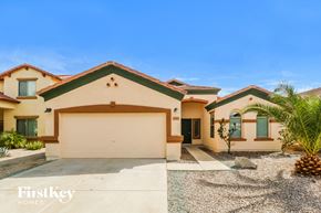 Buckeye house for rent - a house with a garage and a palm tree in front of it