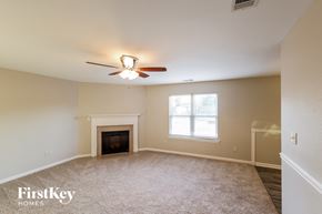 Bessemer house for rent - a living room with a ceiling fan and a fireplace