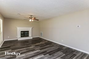 Hoschton house for rent - the living room with wood flooring and a fireplace