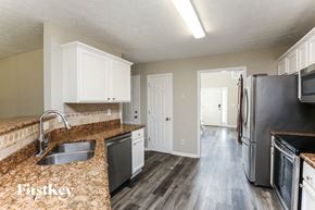 Hoschton house for rent - a kitchen with granite counter tops and stainless steel appliances